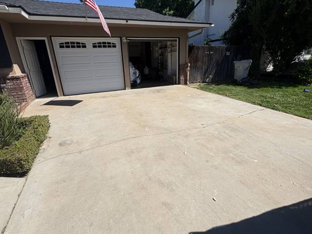 The same driveway swept clear and empty after Rapid Haul removed the remodel debris