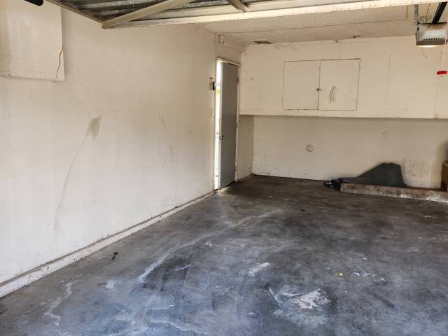 The same garage completely empty with a swept concrete floor after a Rapid Haul cleanout