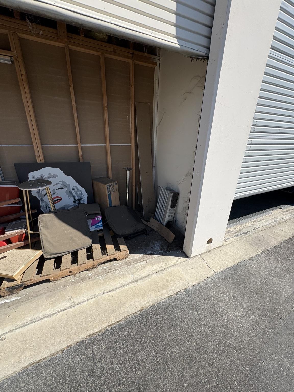 Another angle of storage unit filled with items before cleanout